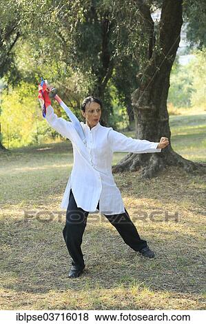 "Tai Chi with a sword, demonstration in an olive grove, Regine Zanini, two-time silver medalist at the Tai Chi Championships 2012, Menton, French Riviera, Alpes-Maritimes, Provence-Alpes-Cote d’Azur, France, Europe" View Large Photo Image Stock Photo - "Tai Chi with a sword, demonstration in an olive grove, Regine Zanini, two-time silver medalist at the Tai Chi Championships 2012, Menton, French Riviera, Alpes-Maritimes, Provence-Alpes-Cote d’Azur, France, Europe". Fotosearch