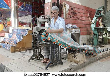 Stock Photo - "Tailor sewing a curtain, Old Market, Sharm el-Sheikh, Sinai Peninsula, Egypt, Africa". Fotosearch