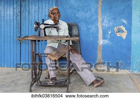 "Tailor sitting in front of his shop in Kalabo, western Zambia" View Large Photo Image Picture - "Tailor sitting in front of his shop in Kalabo, western Zambia". Fotosearch