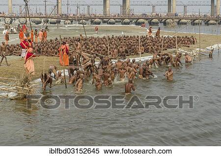 Stock Photography - "Taking a purifying bath as part of the initiation of new sadhus at the Sangam, the confluence of the rivers Ganges, Yamuna and Saraswati, during Kumbha Mela festival, Allahabad, Uttar Pradesh, India, Asia". Fotosearch