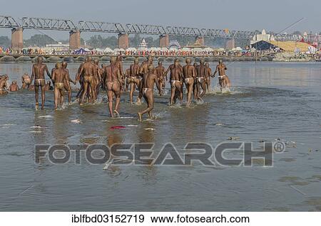 Stock Photo - "Taking a purifying bath in the river Ganges as part of the initiation of new sadhus, during Kumbha Mela festival, Allahabad, Uttar Pradesh, India, Asia". Fotosearch