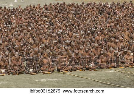 Stock Photo - "Taking their first meal in the new live as part of the initiation of new sadhus at the Sangam, the confluence of the rivers Ganges, Yamuna and Saraswati, during Kumbha Mela festival, Allahabad, Uttar Pradesh, India, Asia". Fotosearch