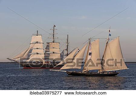 Stock Photo - "Tall ships Scythia and Stad Amsterdam during an evening sail, Hanse Sail 2014 Warnemunde, Mecklenburg-Western Pomerania, Germany, Europe". Fotosearch