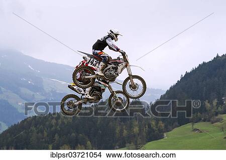 "Tandem jump at the Tyrolean Motocross Championships, Aschau in Zillertal Valley, Tyrol, Austria, Europe" View Large Photo Image Picture - "Tandem jump at the Tyrolean Motocross Championships, Aschau in Zillertal Valley, Tyrol, Austria, Europe". Fotosearch