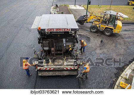 "Tarmac laying machine at a large inner-city road construction site, Essen, North Rhine-Westphalia, Germany, Europe" View Large Photo Image Stock Image - "Tarmac laying machine at a large inner-city road construction site, Essen, North Rhine-Westphalia, Germany, Europe". Fotosearch