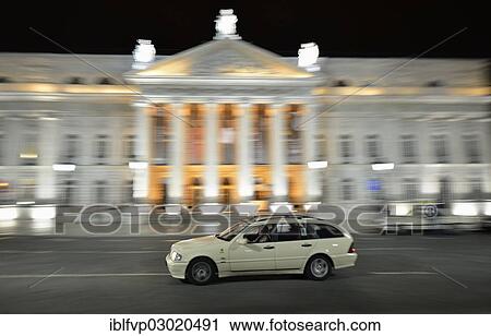 Stock Image - "Taxi at night in front of the Teatro Dona Maria II National Theatre in Rossio Square, or Praca Dom Pedro IV, Lisbon, Portugal, Europe". Fotosearch