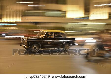 "Taxi in motion on a street at night, Mumbai, Maharashtra, India, Asia" View Large Photo Image Stock Photo - "Taxi in motion on a street at night, Mumbai, Maharashtra, India, Asia". Fotosearch