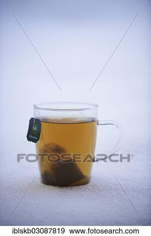 Tea cup with herbal tea standing in the snow View Large Photo Image Stock Photo - Tea cup with herbal tea standing in the snow. Fotosearch