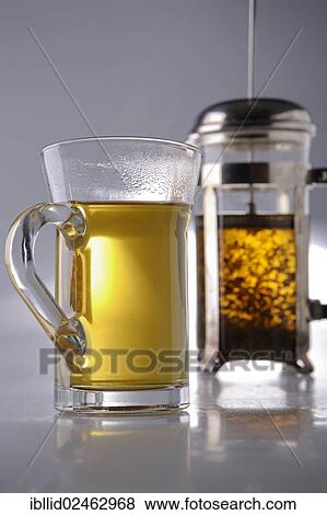 Tea glass in front of a teapot with herbal tea View Large Photo Image Stock Photo - Tea glass in front of a teapot with herbal tea. Fotosearch