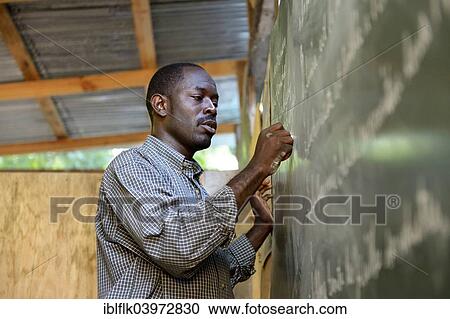 "Teacher writing on the blackboard, Fort National, Port-au-Prince, Haiti, North America" View Large Photo Image Stock Image - "Teacher writing on the blackboard, Fort National, Port-au-Prince, Haiti, North America". Fotosearch