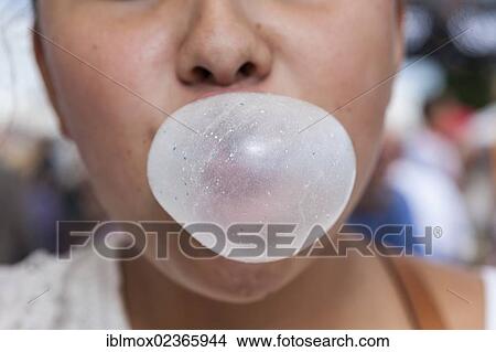 Picture - "Teenager, 14 years, blowing bubbles with a chewing gum, Hesse, Germany, Europe". Fotosearch