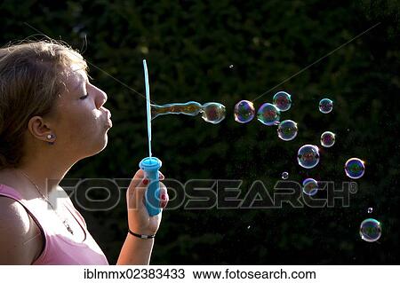 "Teenager blowing soap bubbles, Germany, Europe" View Large Photo Image Stock Image - "Teenager blowing soap bubbles, Germany, Europe". Fotosearch