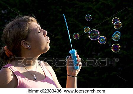 "Teenager blowing soap bubbles, Germany, Europe" View Large Photo Image Stock Photograph - "Teenager blowing soap bubbles, Germany, Europe". Fotosearch