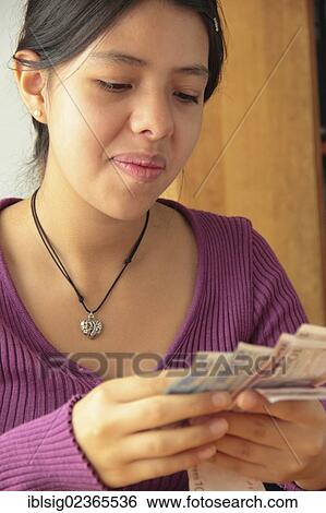 Teenager holding Euro notes View Large Photo Image Stock Photograph - Teenager holding Euro notes. Fotosearch