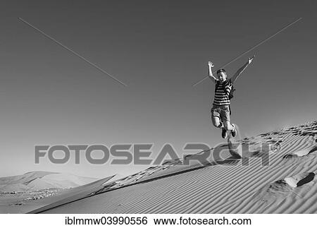 "Teenager jumping and running down a dune, Sossusvlei, Namib Desert, Namibia, Africa" View Large Photo Image Stock Photograph - "Teenager jumping and running down a dune, Sossusvlei, Namib Desert, Namibia, Africa". Fotosearch