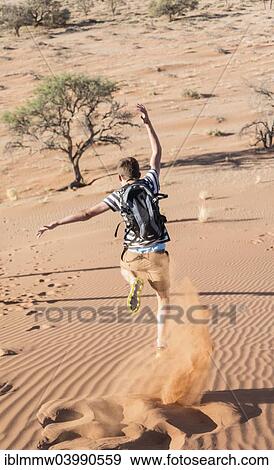 "Teenager running down a dune, Sossusvlei, Namib Desert, Namibia, Africa" View Large Photo Image Stock Photo - "Teenager running down a dune, Sossusvlei, Namib Desert, Namibia, Africa". Fotosearch