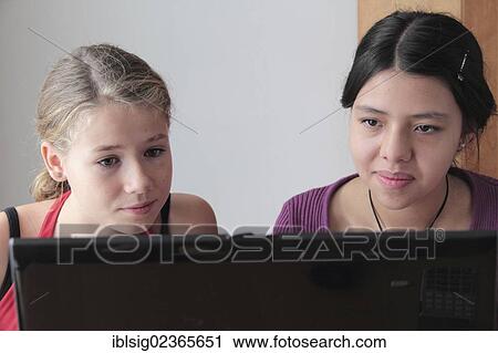 Teenagers on a laptop computer View Large Photo Image Stock Image - Teenagers on a laptop computer. Fotosearch