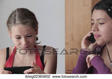 Teenagers on smartphones View Large Photo Image Stock Image - Teenagers on smartphones. Fotosearch