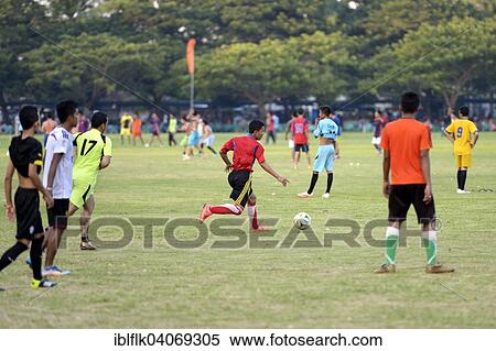 "Teenagers playing football in a public park, Banda Aceh, Indonesia, Asia" View Large Photo Image Stock Photography - "Teenagers playing football in a public park, Banda Aceh, Indonesia, Asia". Fotosearch