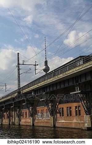 Television tower at Alexanderplatz square, viewed across the Spree river, railway lines at front, Berlin, Germany, Europe View Large Photo Image Stock Image - Television tower at Alexanderplatz square, viewed across the Spree river, railway lines at front, Berlin, Germany, Europe. Fotosearch