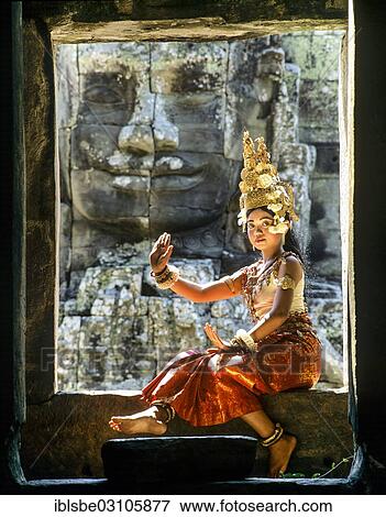 "Temple dancer or apsara sitting in a window in front of a face tower at Bayon Temple, UNESCO World Cultural Heritage Site, Angkor Thom, Siem Reap, Siem Reap Province, Cambodia, Asia" View Large Photo Image Stock Photo - "Temple dancer or apsara sitting in a window in front of a face tower at Bayon Temple, UNESCO World Cultural Heritage Site, Angkor Thom, Siem Reap, Siem Reap Province, Cambodia, Asia". Fotosearch