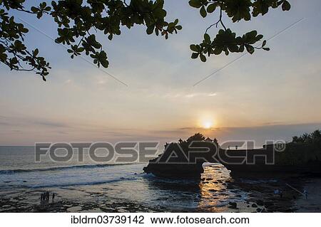 Stock Image - "Temple of the Tanah Lot temple complex on the south coast at sunset, Tanah Lot, Bali, Indonesia, Asia". Fotosearch