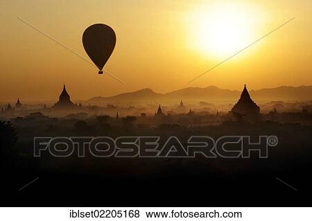 "Temples, pagodas and a hot air balloon at sunrise, Bagan, Burma, Myanmar, Southeast Asia, Asia" View Large Photo Image Stock Photo - "Temples, pagodas and a hot air balloon at sunrise, Bagan, Burma, Myanmar, Southeast Asia, Asia". Fotosearch