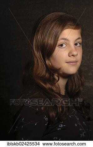 "Tennage girl with long hair wearing a brown blouse, portrait" View Large Photo Image Picture - "Tennage girl with long hair wearing a brown blouse, portrait". Fotosearch