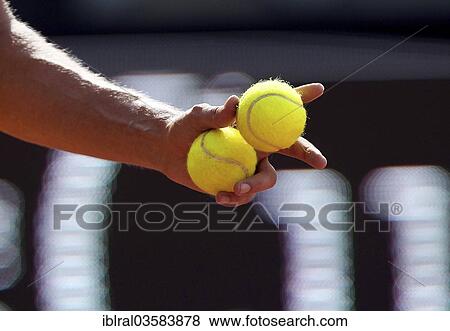 "Tennis player holding tennis balls in his hand, Germany, Europe" View Large Photo Image Stock Photo - "Tennis player holding tennis balls in his hand, Germany, Europe". Fotosearch