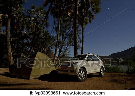 "Tent and safari vehicle at night on a campsite near Epupa Falls, Epupa, Kaokoland, Kunene, Namibia, Africa" View Large Photo Image Stock Image - "Tent and safari vehicle at night on a campsite near Epupa Falls, Epupa, Kaokoland, Kunene, Namibia, Africa". Fotosearch