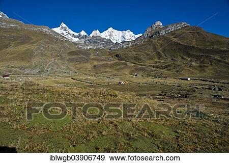 Stock Photo - "Tent camp, at the back the snow-capped Mt Trapecio and Mt Nevados Jurau, Cordillera Huayhuash mountain range, Northern Peru, Peru, South America". Fotosearch
