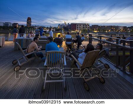 "Terrace, Oosten restaurant and bar, skyline of Frankfurt at the back, Ostend, Frankfurt am Main, Hesse, Germany, Europe" View Large Photo Image Stock Photography - "Terrace, Oosten restaurant and bar, skyline of Frankfurt at the back, Ostend, Frankfurt am Main, Hesse, Germany, Europe". Fotosearch