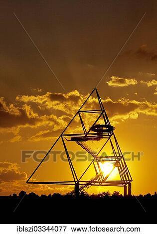 "Tetraeder, a tetrahedron as an artwork on the Beckstrasse slag heap, at sunset, Batenbrock, Bottrop, Ruhr district, North Rhine-Westphalia, Germany, Europe" View Large Photo Image Stock Photo - "Tetraeder, a tetrahedron as an artwork on the Beckstrasse slag heap, at sunset, Batenbrock, Bottrop, Ruhr district, North Rhine-Westphalia, Germany, Europe". Fotosearch