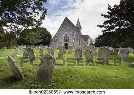 Stock Photo - "The 12C Church St Thomas a Becket, Warblington and gravestones in the churchyard, Havant, Hampshire, England, United Kingdom, Europe". Fotosearch