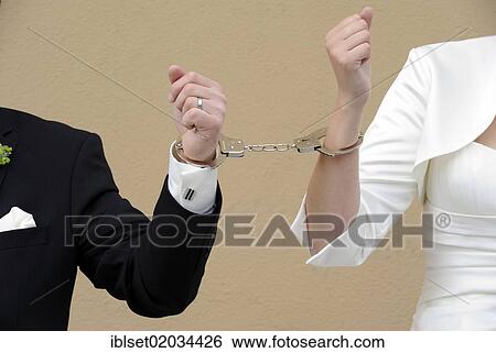 The arms of a wedding couple connected with handcuffs View Large Photo Image Stock Photograph - The arms of a wedding couple connected with handcuffs. Fotosearch