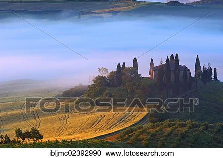 Stock Image - "The Belvedere at dawn, morning fog, San Quirico d'Orcia, Val d'Orcia, Orcia Valley, UNESCO World Heritage Site, Siena Province, Tuscany, Italy, Europe". Fotosearch