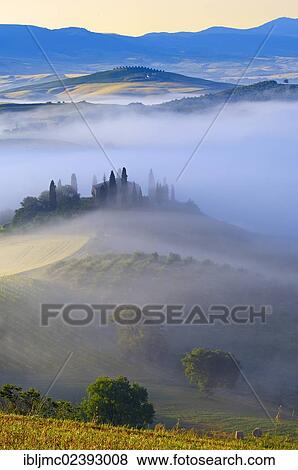 Stock Photo - "The Belvedere farm at dawn, morning fog, Val d'Orcia, Orcia Valley, UNESCO World Heritage Site, Siena Province, Tuscany, Italy, Europe". Fotosearch