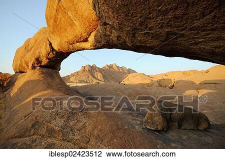 The Bridge rock formation in the evening sun, natural stone arch, Pontok Mountains, Great Spitzkoppe Mountain, Spitzkoppe, Grosse Spitzkuppe Nature Reserve, Namibia, Africa View Large Photo Image Stock Image - The Bridge rock formation in the evening sun, natural stone arch, Pontok Mountains, Great Spitzkoppe Mountain, Spitzkoppe, Grosse Spitzkuppe Nature Reserve, Namibia, Africa. Fotosearch