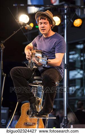 "The British singer songwriter Jon Kenzie playing live outside KKL Plaza at the Blue Balls Festival, Lucerne, Switzerland, Europe" View Large Photo Image Stock Photo - "The British singer songwriter Jon Kenzie playing live outside KKL Plaza at the Blue Balls Festival, Lucerne, Switzerland, Europe". Fotosearch