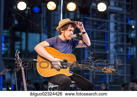 "The British singer songwriter Jon Kenzie playing live outside KKL Plaza at the Blue Balls Festival, Lucerne, Switzerland, Europe" View Large Photo Image Stock Photograph - "The British singer songwriter Jon Kenzie playing live outside KKL Plaza at the Blue Balls Festival, Lucerne, Switzerland, Europe". Fotosearch