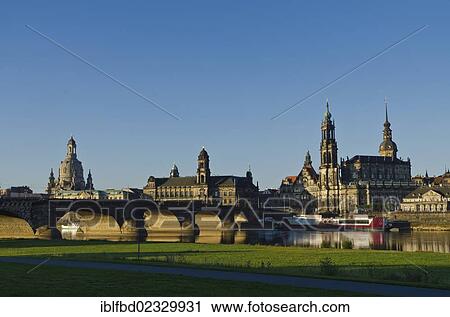 Stock Image - "The """"Bruehlsche Terasse"""", the """"Frauenkirche"""", and the church """"Hofkirche"""" seen from across the river Elbe. Dresden, Germany, Europe". Fotosearch