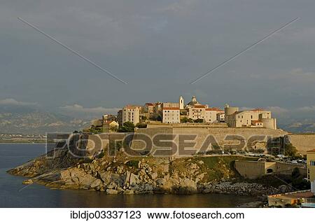 "The citadel (castle) of Calvi surrounded by the mediterranean sea in front of the steep mountains of Corsica. Calvi is in the department Haute-Corse, France on the mediterranean island of Corsica, Calvi, Corsica, France, Europe" View Large Photo Image Stock Image - "The citadel (castle) of Calvi surrounded by the mediterranean sea in front of the steep mountains of Corsica. Calvi is in the department Haute-Corse, France on the mediterranean island of Corsica, Calvi, Corsica, France, Europe". Fotosearch