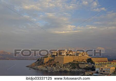 "The citadel (castle) of Calvi surrounded by the mediterranean sea in front of the steep mountains of Corsica. Calvi is in the department Haute-Corse, France on the mediterranean island of Corsica, Calvi, Corsica, France, Europe" View Large Photo Image Stock Photography - "The citadel (castle) of Calvi surrounded by the mediterranean sea in front of the steep mountains of Corsica. Calvi is in the department Haute-Corse, France on the mediterranean island of Corsica, Calvi, Corsica, France, Europe". Fotosearch