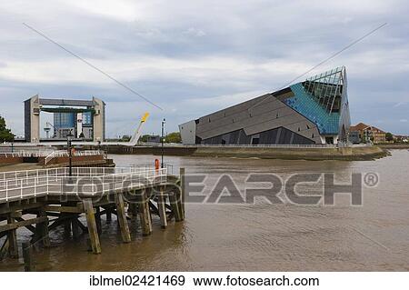 The Deep and The River Hull tidal barrier viewed from the west bank of the river Hull, Kingston upon Hull, East Riding of Yorkshire, England, United Kingdom, Europe View Large Photo Image Stock Photo - The Deep and The River Hull tidal barrier viewed from the west bank of the river Hull, Kingston upon Hull, East Riding of Yorkshire, England, United Kingdom, Europe. Fotosearch