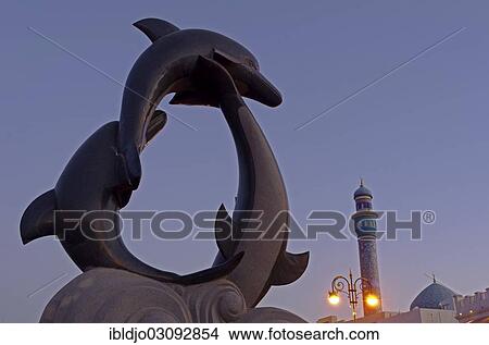 "The dolphin statue and the minaret of the Rasool Azam Mosque, Muttrah, Muscat Governorate (Capital Area, Oman, Asia" View Large Photo Image Picture - "The dolphin statue and the minaret of the Rasool Azam Mosque, Muttrah, Muscat Governorate (Capital Area, Oman, Asia". Fotosearch