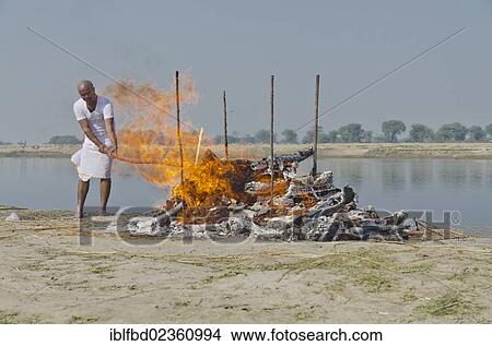 "The eldest son maintaining the fire as part of a cremation ceremony, Vrindavan, India, Asia" View Large Photo Image Picture - "The eldest son maintaining the fire as part of a cremation ceremony, Vrindavan, India, Asia". Fotosearch