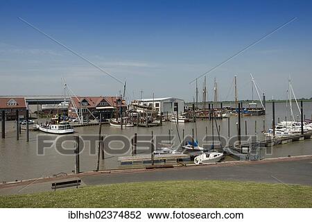 "The ferry to Emden and some pleasure crafts in the harbour, fishing village of Ditzum, East Frisia, Lower Saxony, Germany, Europe" View Large Photo Image Stock Image - "The ferry to Emden and some pleasure crafts in the harbour, fishing village of Ditzum, East Frisia, Lower Saxony, Germany, Europe". Fotosearch