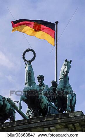 Stock Photo - "The flag of the GDR flying above the Quadriga on Brandenburg Gate, April 1990, Berlin, Berlin, Germany, Europe". Fotosearch