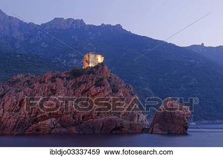 "The flood lit Genoese Tower of Porto on top of a rocky hill and the Gulf of Porto at the blue hour, at dusk, Guaita, Porto, Corsica, France, Europe" View Large Photo Image Stock Photo - "The flood lit Genoese Tower of Porto on top of a rocky hill and the Gulf of Porto at the blue hour, at dusk, Guaita, Porto, Corsica, France, Europe". Fotosearch