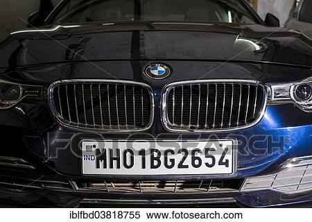 Stock Photography - "The front of a German BMW car with a Maharasthra number plate, a typical status symbol for rich middle class Indians, Mumbai, Maharashtra, India, Asia". Fotosearch